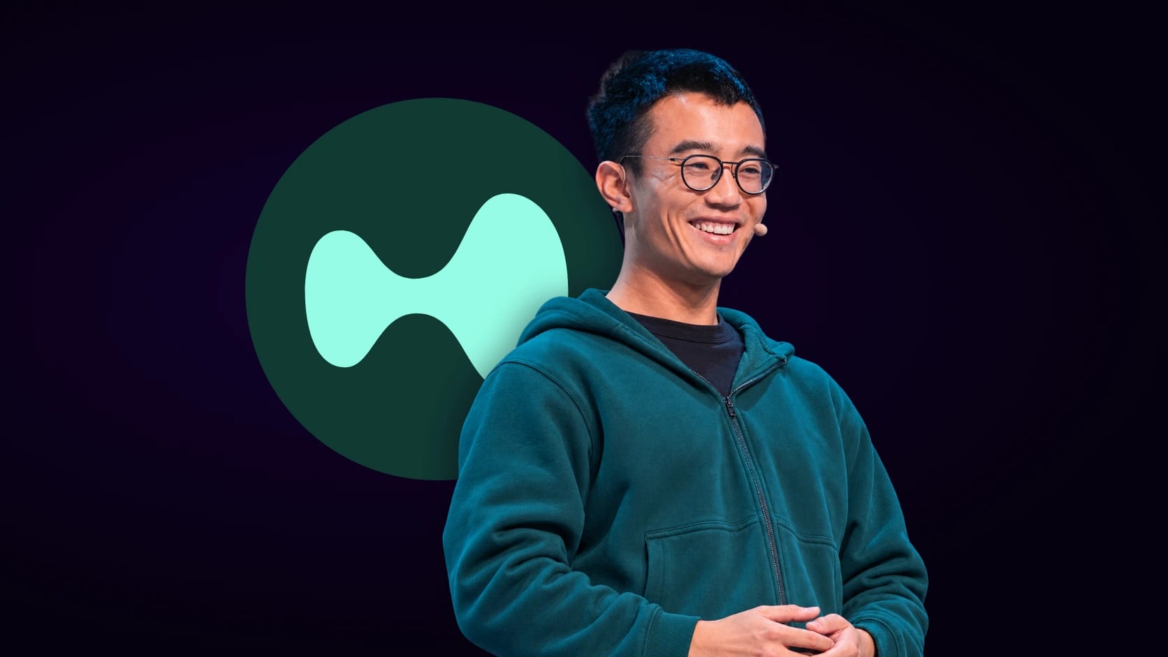 Jeff Yan in front of the circular Hyperliquid logo on a dark background