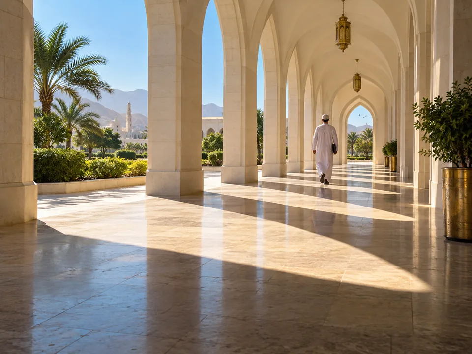 White Omani arched arcade of an office building in Muscat with hard shadows and a person seen from behind, units in a sandbox with blockchain in Oman