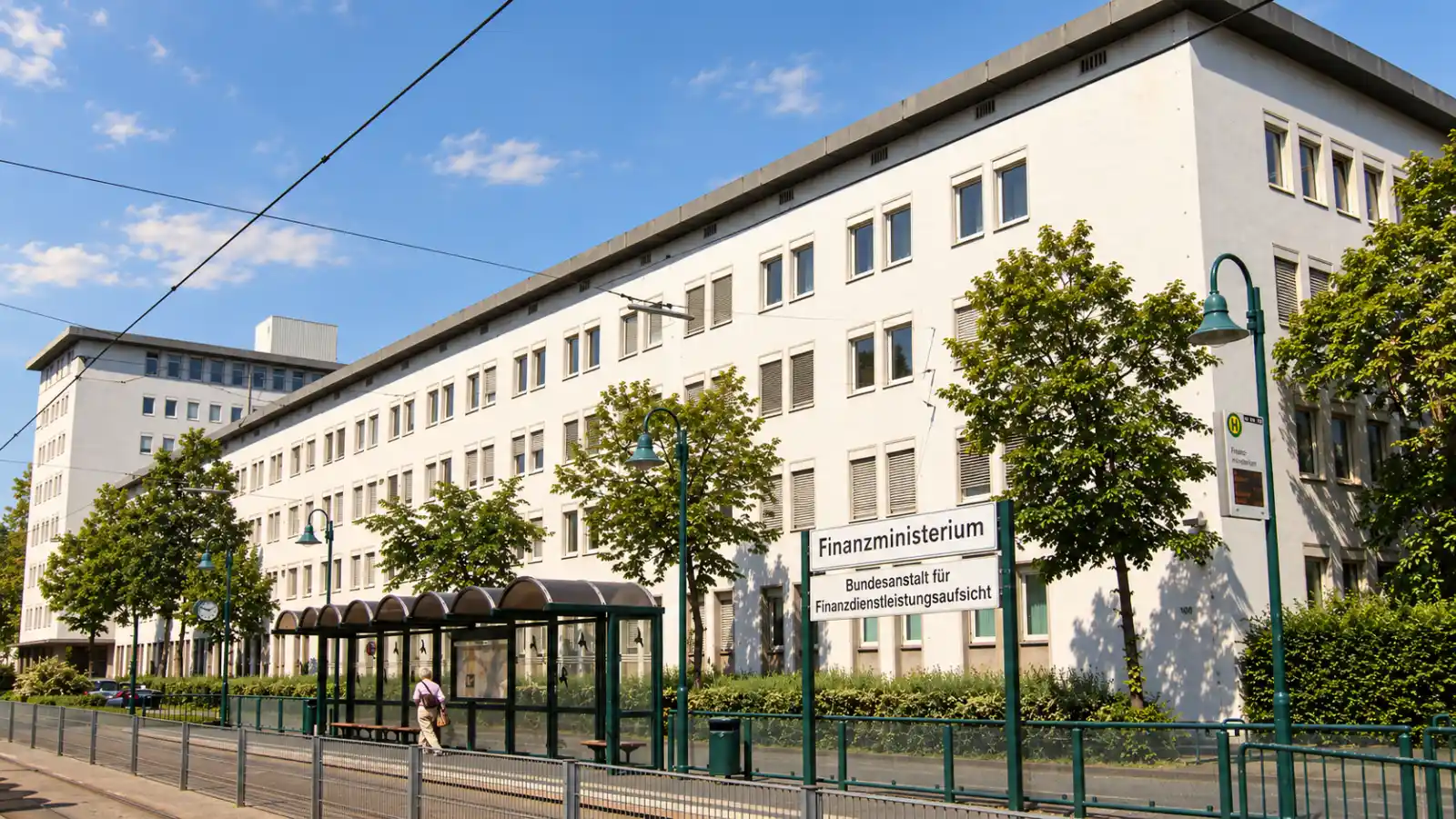 BaFin building in Bonn, with a white facade and identifying sign beside the tram stop
