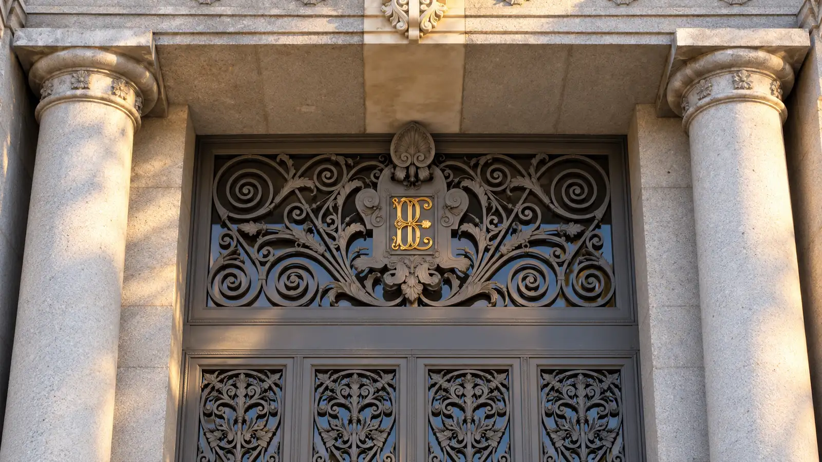 Stone columns and ironwork bearing the Bank of Spain monogram in Madrid