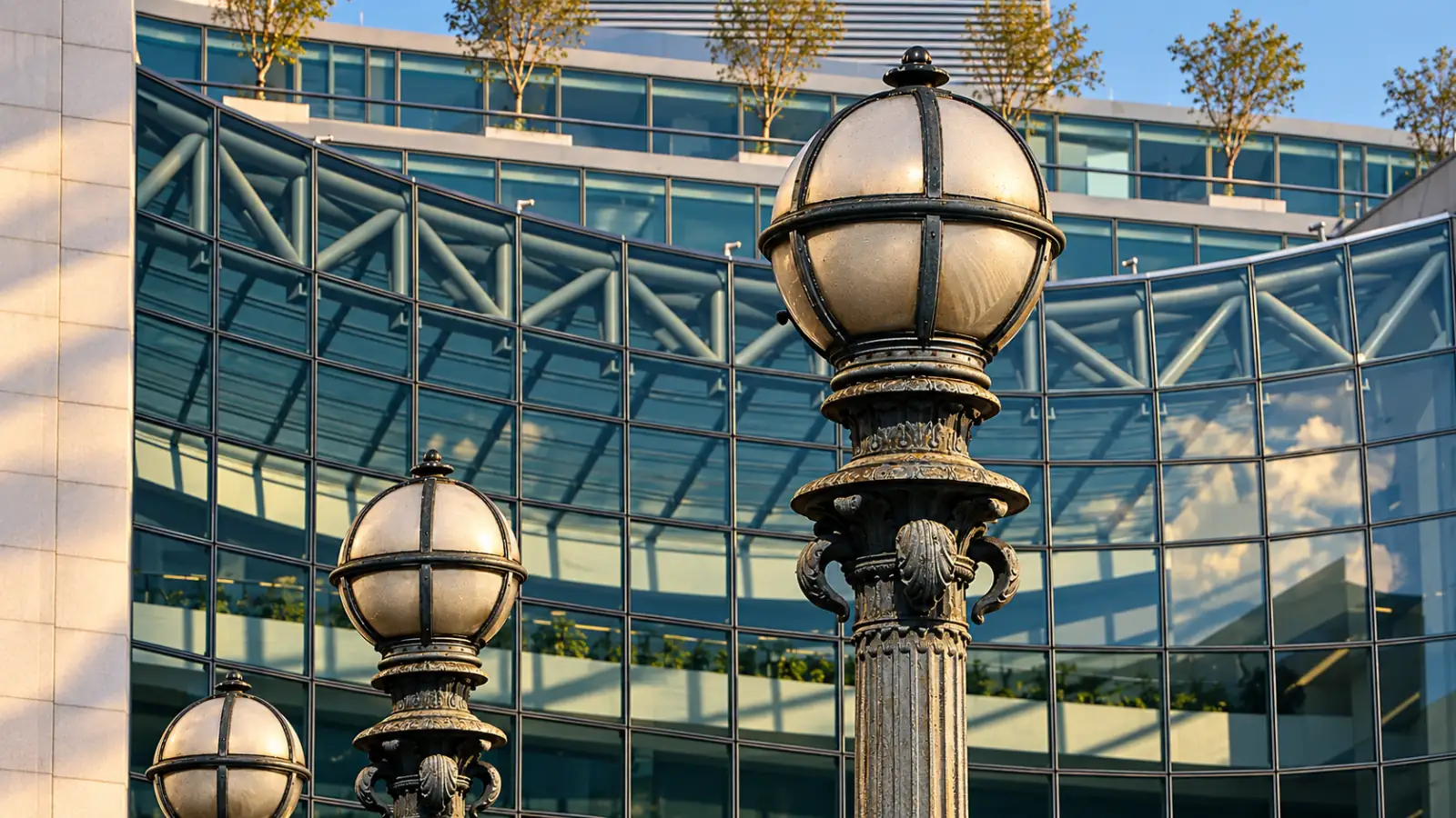 Metal street lamps in front of the curved glass facade of SEC headquarters in Washington, D.C