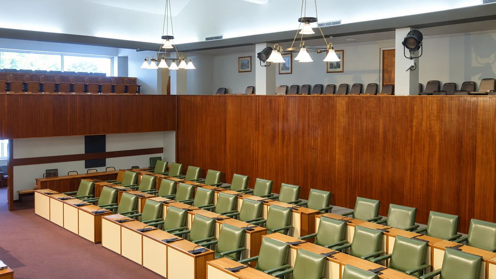 Green seats and wooden galleries in the Gordon House chamber