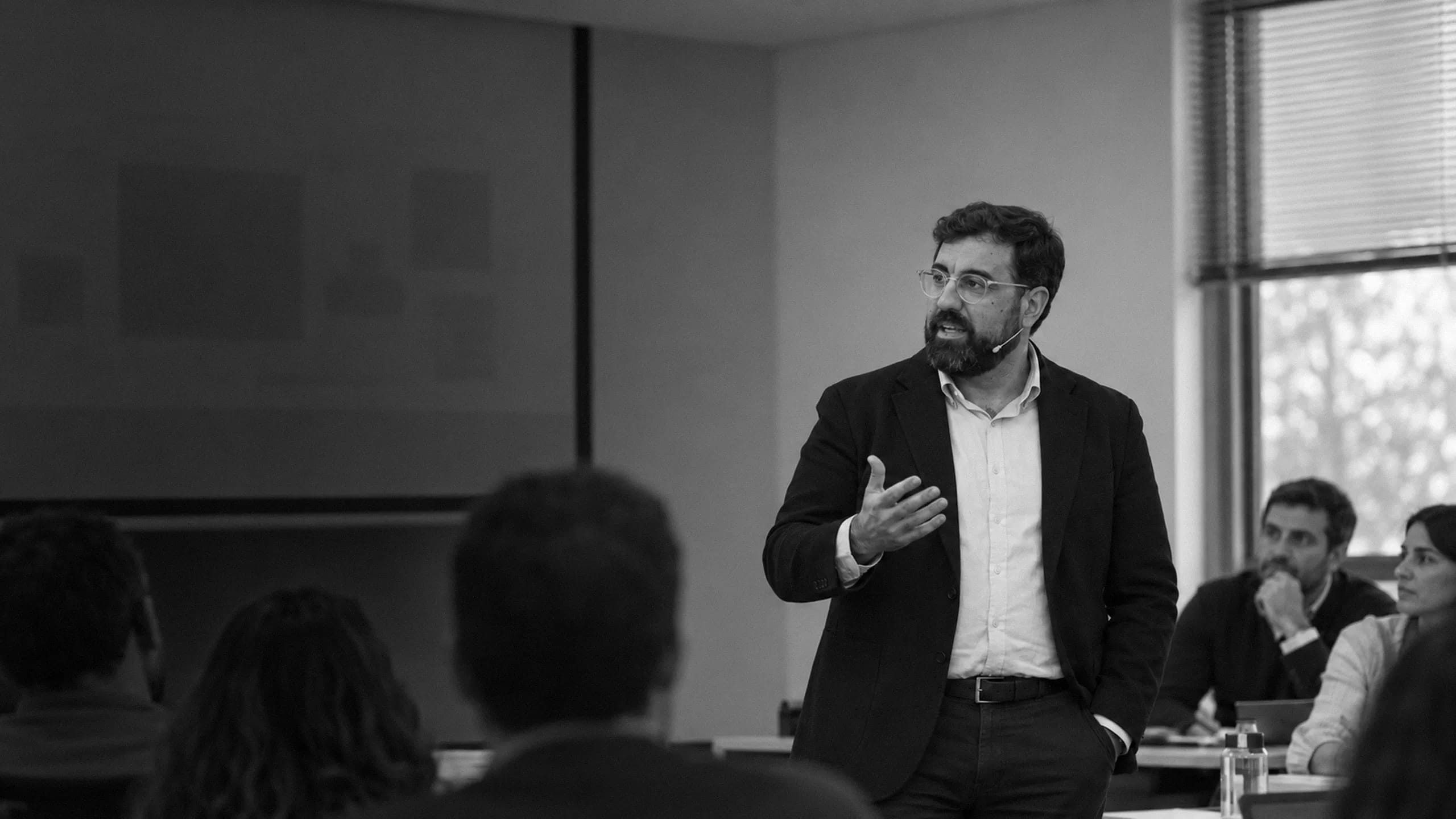 Speaker delivering a blockchain training session to a team