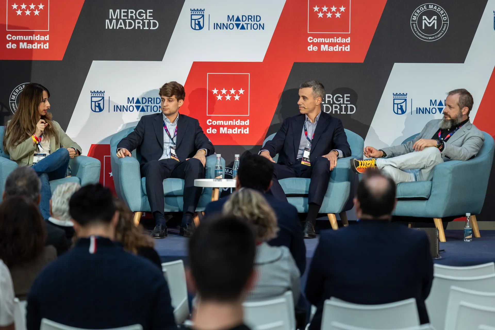 Audience seated in front of the MADRID Stage during the panel with COX, Onyze and Metlabs
