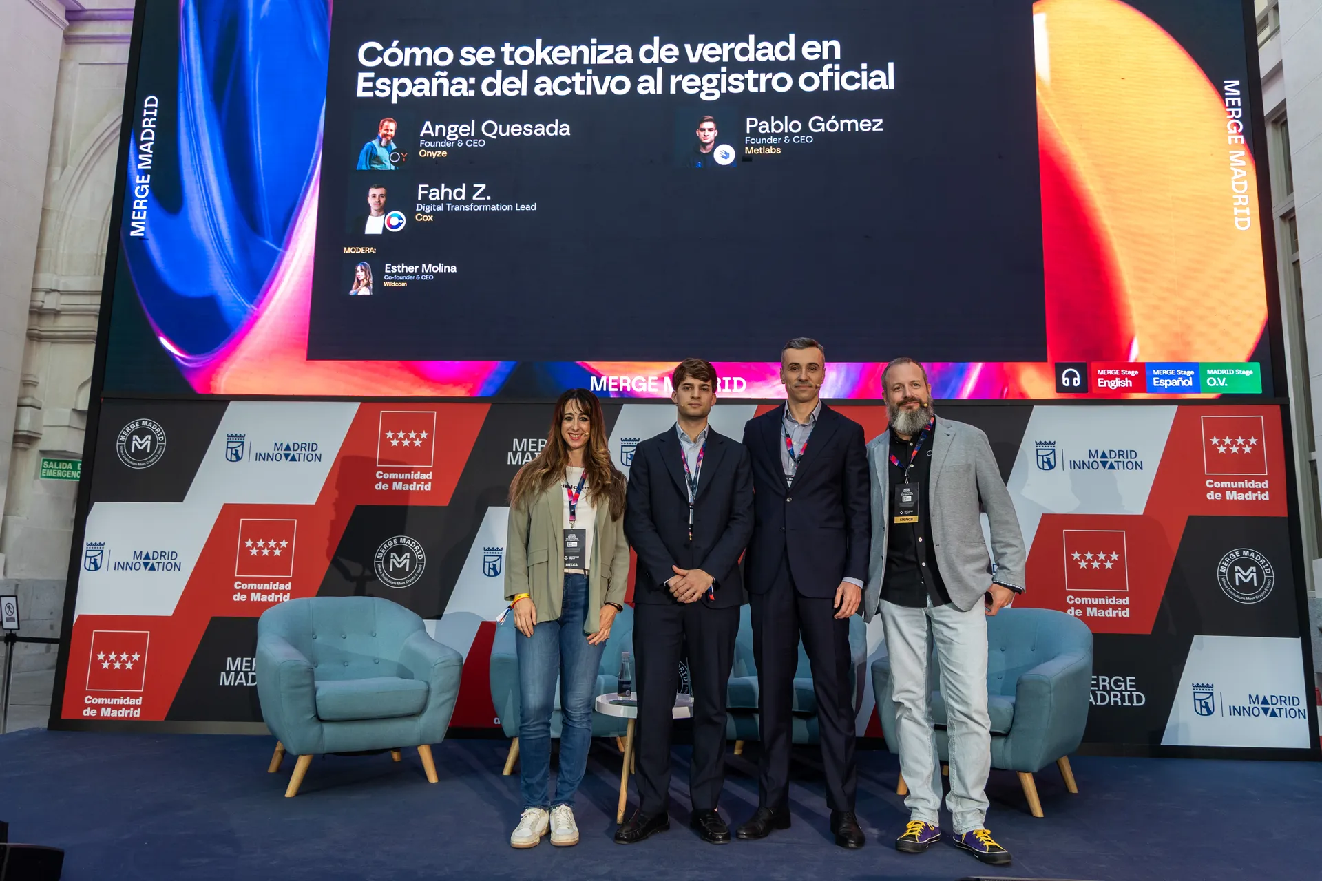 Esther Molina, Pablo Gómez, Fahd Zniber and Ángel Quesada posing on the MADRID Stage beneath the screen showing the panel title